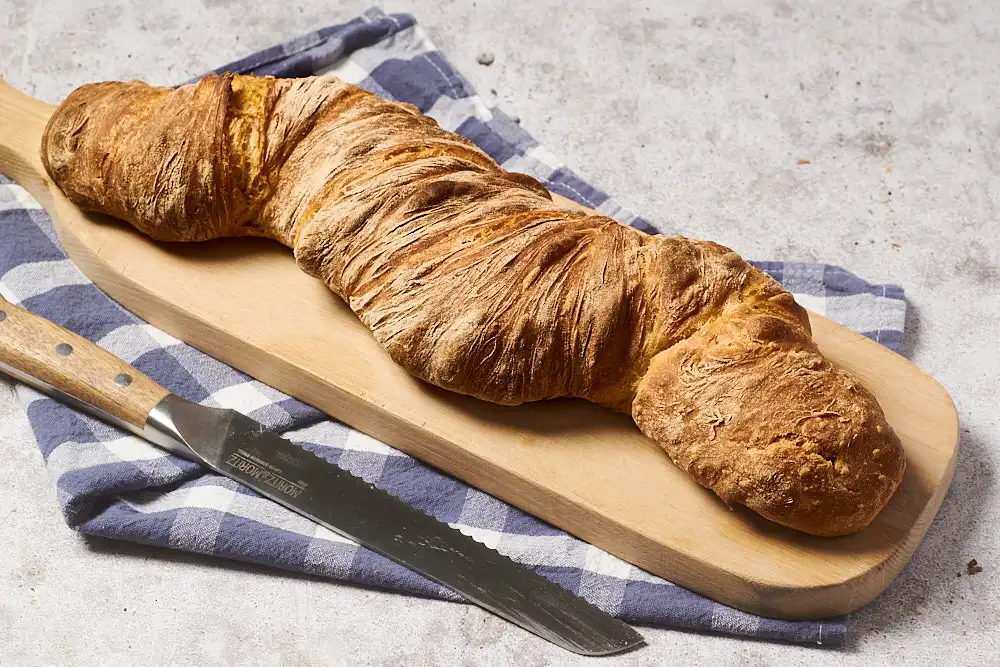 Wurzelbrot Rezept – fertig gebackener Martins-Zwirbel mit knuspriger Kruste auf einem Holzbrett